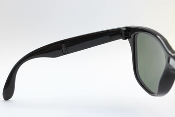Black folding wayfarer sunglasses leg fashion for wearing isolated on white background closeup.