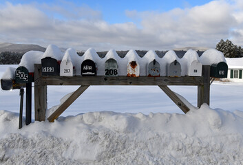 Mailboxes covered with fresh snow along rural road - 485228357