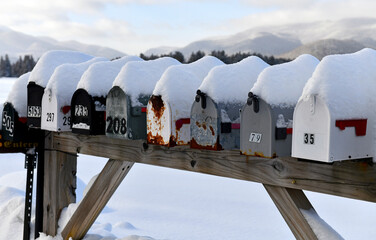 Mailboxes covered with fresh snow along rural road - 485228372