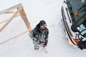 The sculptor carves a graceful composition on the ice panel