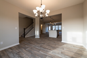 Empty modern townhouse floor showcasing a kitchen with living and dinning room ready to be moved...