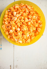 A plate of sweet popcorn on an old white table