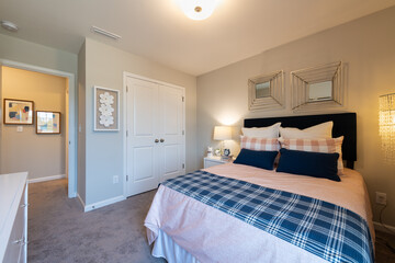 Furnished cozy bedroom in a town home. Home decorating or real estate concept.