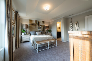 Furnished contemporary master bedroom in a town home. Home decorating or real estate concept.