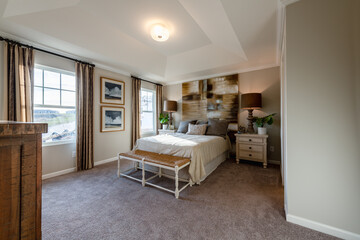 Furnished contemporary master bedroom in a town home. Home decorating or real estate concept.