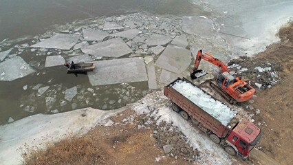 Workers use heavy trucks to transport ice, North China