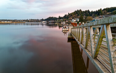 Fototapeta na wymiar Boat dock at sundown on the Willapa River at South Bend in Washington, USA