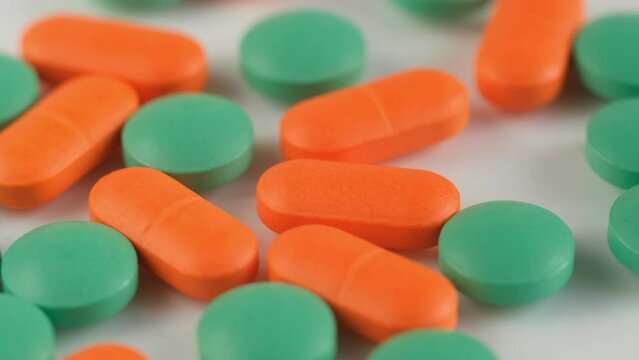 Slow Motion Shot of rotation Colorful Pills on wite Background. 4K