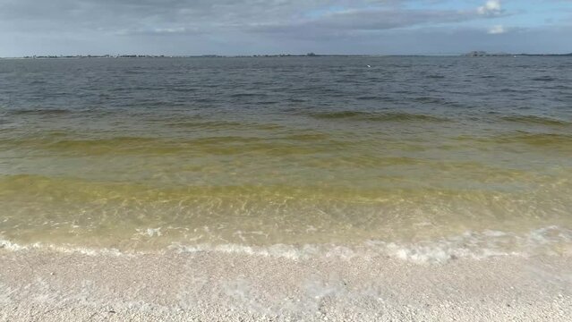 Ocean waves rolling in with horizon in background