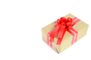 Brown craft gift box with red ribbon bow isolated on white background.
