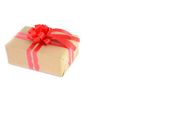Brown craft gift box with red ribbon bow isolated on white background.