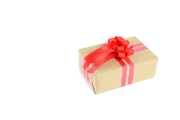 Brown craft gift box with red ribbon bow isolated on white background.