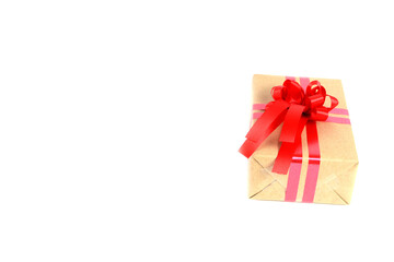 Brown craft gift box with red ribbon bow isolated on white background.