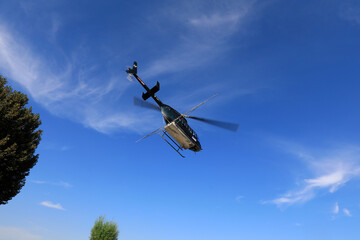 an agricultural helicopter flying against American white moth flies from the landing point to the spraying area, North China