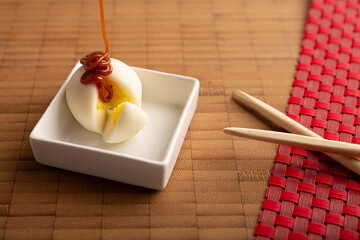 Ice cream mini Mochi with caramel (cajeta). Traditional Japanese dessert made from rice flour. Close up on bamboo surface.