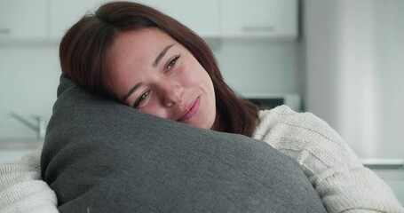 Beautiful smillimg women hugging her pillow. Concept of dreaming, carelessness, appeasement