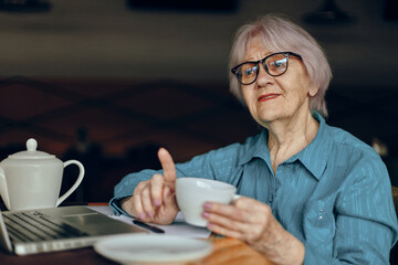 A businesswoman in a cafe a cup of drink laptop Freelancer works unaltered