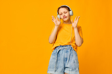 pretty girl listening to music on headphones Youth style isolated backgrounds unaltered