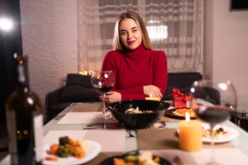 Woman romantic dinner at home with glass of red wine, date with mistress online, lonely celebration of valentine's day or birthday distance