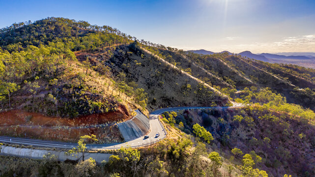 Horizontal shot of two cars on road in Mount Morgan