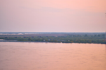 Khabarovsk, Russia - Aug, 14, 2021: Bridge over the Amur River in Khabarovsk, Russia. Evening photography.