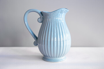 Beautiful textured blue jug for drinks close-up.