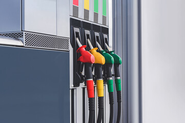 Petrol station with colored guns and fuel hoses. Gasoline, diesel, eco hydrogen refueling column.....