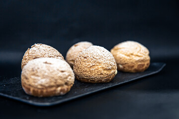 Appetizing Shu cakes on a black background.