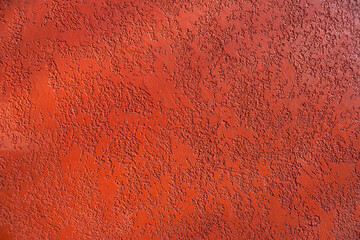 Close-up, texture of a red facade made of decorative plaster.