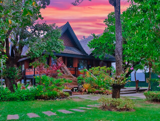 beautiful Wat Chalong Buddhist temples in Phuket Thailand. Decorated in beautiful ornate colours of red and Gold and Blue. Lovely sunset