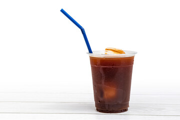 black coffee or ice americano in a cup with blue straw on white background