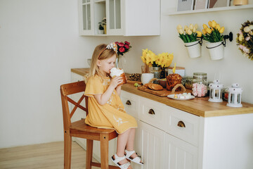 A little girl is eating sweets prepared for the Easter holiday.