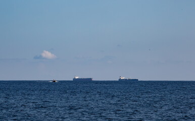 merchant ships on the roadstead in the bay of the city of Novorossiysk on a clear sunny day in summer