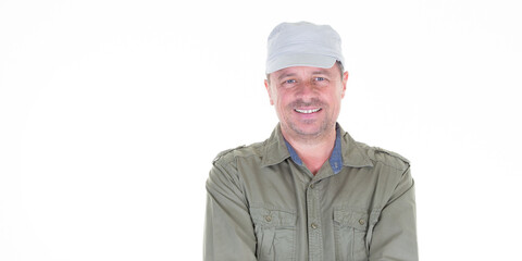 Happy man wearing beige military cap aside copy space in white background