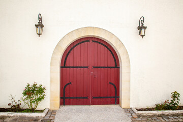 Double Wooden Door building entrance closed with arch on street with copy space on wall