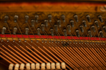 A close-up view inside all the strings of the piano.