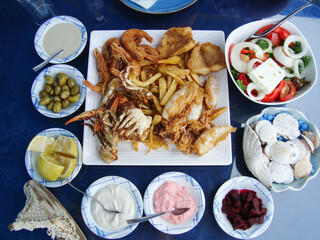 mediterranean cuisine. seafood. table setting. authentic greek meze style dishes on the table