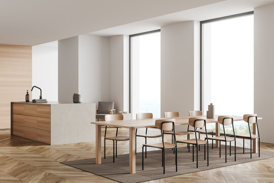 Light kitchen interior with chairs and table, countertop and panoramic window