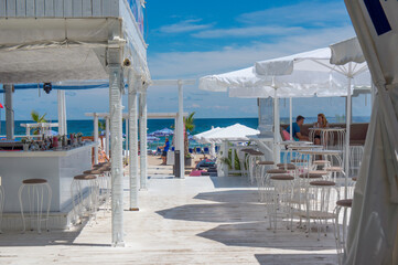 Beach bar on a white wooden terrace. Beach near Sozopol. Bulgaria