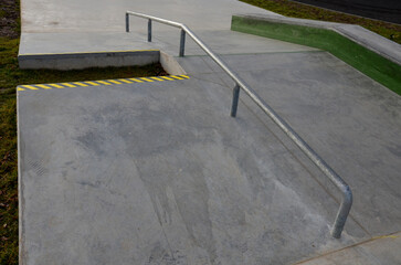 Skateboard park with concrete cement surface with concrete skateboard obstacles is designed for roller sports. Cycling is not allowed except for freestyle bikes. icing winter morning sunrise