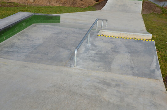 Skateboard park with concrete cement surface with concrete skateboard obstacles is designed for roller sports. Cycling is not allowed except for freestyle bikes. icing winter morning sunrise