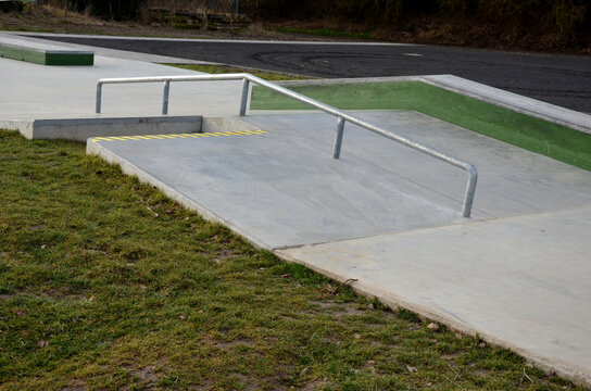 Skateboard park with concrete cement surface with concrete skateboard obstacles is designed for roller sports. Cycling is not allowed except for freestyle bikes. icing winter morning sunrise