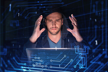 Handsome businessman in hoodie at workplace working with laptop to optimize development by implying...