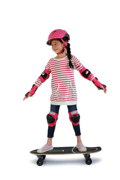 Portrait of Asian little girl skateboarder with wearing safety and protective equipment stand on skateboard isolated on white background. Image with Clipping path.