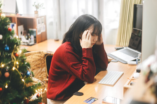 Single young adult asian business woman stress and depression at home on christmas holidays.
