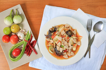 Papaya Salad (Som Tam) the traditional Thai foods on wood table background. Most wanted popular food in Thailand. Above view