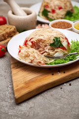 Delicious chicken aspic on a plate on concrete table