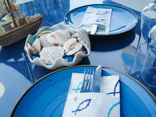 festive table setting in a cafe on a marine theme in blue tones
