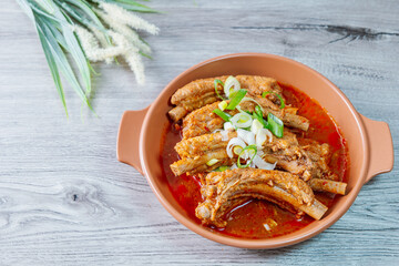 Deunggalbijjim, Korean Braised Pork Rib : For this dish, pig backbone is braised with mukeunji (aged kimchi). After being seasoned and simmered in broth, the mukeunji becomessoft and savory.