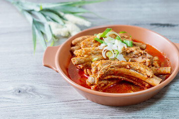 Deunggalbijjim, Korean Braised Pork Rib : For this dish, pig backbone is braised with mukeunji (aged kimchi). After being seasoned and simmered in broth, the mukeunji becomessoft and savory.